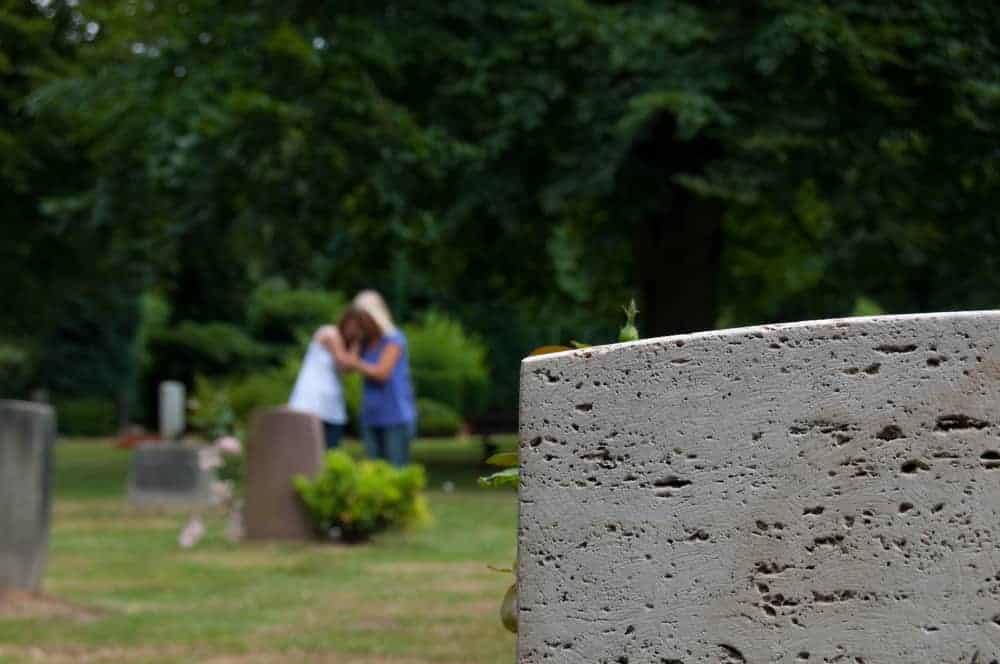 wrongful death attorney snohomish county - people grieving at a cemetery