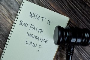 Concept of What is Bad Faith Insurance Law? write on a book with gavel isolated on Wooden Table.
